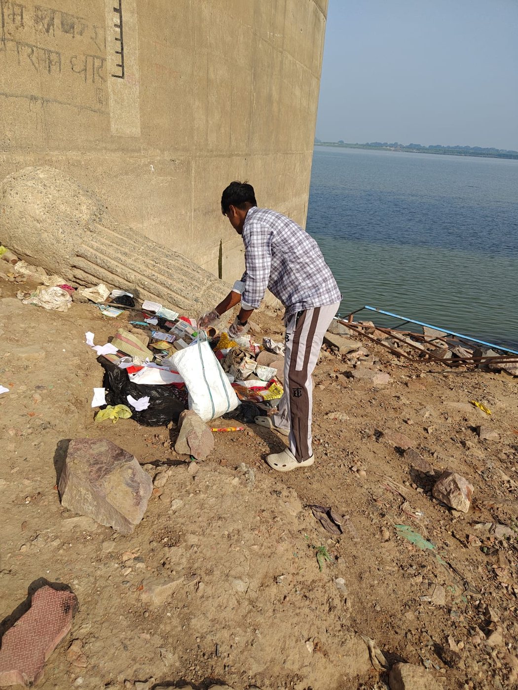 Clearing waste along the Ganga